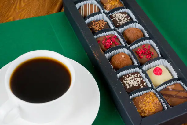 delicious chocolate candies in gift box with coffee cup