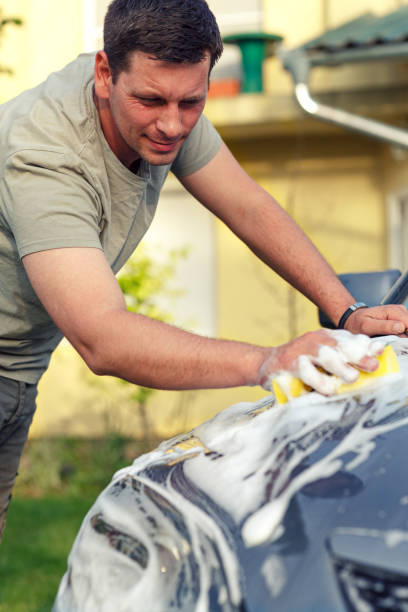 istock male washing car with a sponge and foam 1011955580