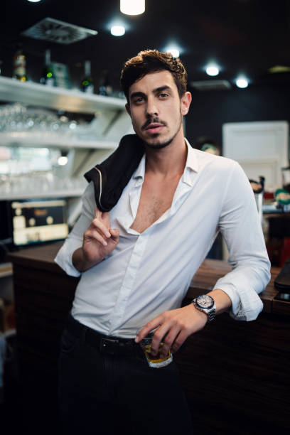 istock Elegant man drinking whiskey in the bar 1011955618