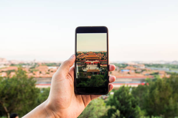 Traveling takes smart phone picture of Forbidden City,Beijing Traveling takes smart phone picture of Forbidden City,Beijing forbidden city beijing architecture chinese ethnicity stock pictures, royalty-free photos & images