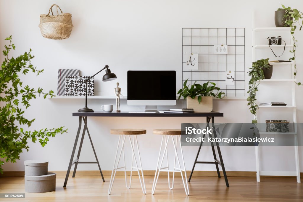 Desktop computer mock-up on an industrial desk in a scandinavian student bedroom interior workspace with white walls Home Office Stock Photo