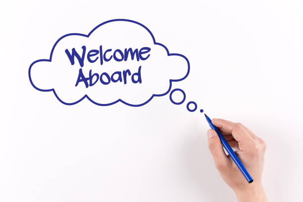 istock Hand writing Welcome Aboard on white paper, View from above 1011964576