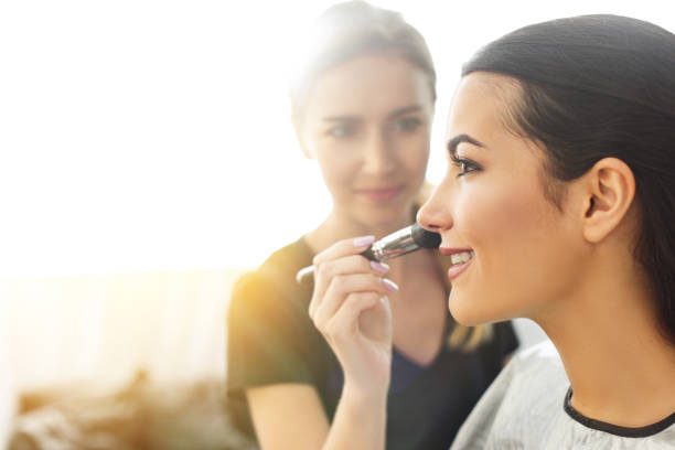 selective focus of makeup artist applying powder on womans face with brush selective focus of makeup artist applying powder on womans face with brush makeup artist stock pictures, royalty-free photos & images