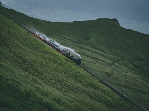 old steam train on a mountain track in the swiss alps, brienzer rothorn bahn in switzerland