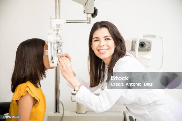 Confident Optometrist Examining Patient Eyes Stock Photo - Download Image Now - Ophthalmologist, Optometrist, Optometry