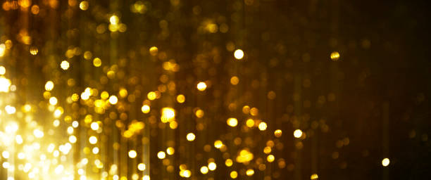 istock Christmas Gold light background.  Holiday glowing backdrop. Defocused Background With Blinking Stars. Blurred Bokeh. 1011972512