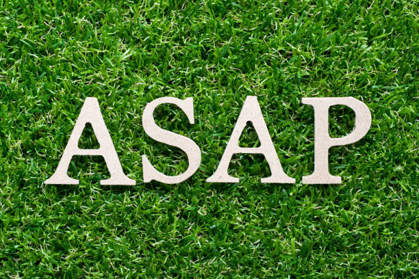 istock Wood alphabet in word ASAP (Abbreviation of as soon as possible) on artificial green grass background 1011974892