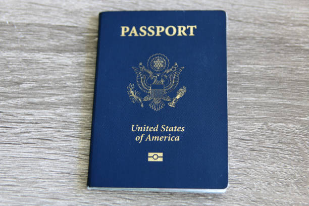 U.S. Passport with Microchip U.S. Passport with Microchip over a light grey wooden background blue us passport cover stock pictures, royalty-free photos & images