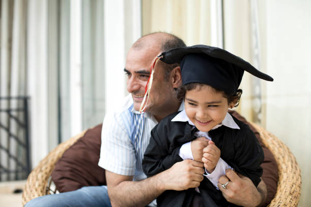 istock Father embracing little graduate 1011979354