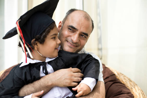 istock Father embracing little graduate 1011983410