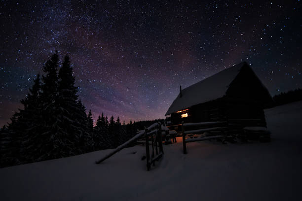 istock Cabin under stars in winter 1011984410
