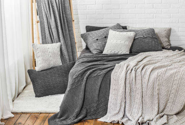 istock bedroom in gray white tones knitted plaid pillow bed 1011987008