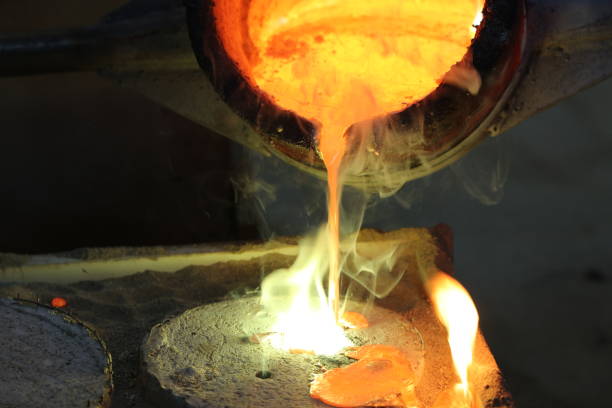 istock Foundry - molten metal poured from ladle into mould 1012002828