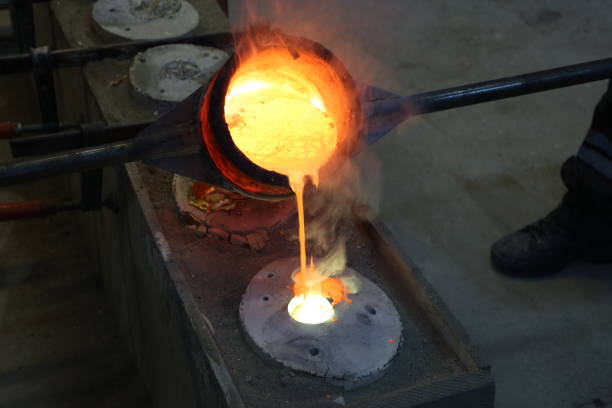 istock Foundry - molten metal poured from ladle into mould 1012002836