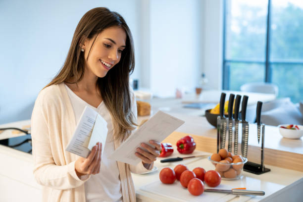 istock Happy woman at home checking her mail 1012003180