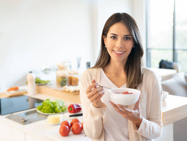 istock Woman at home eating a healthy breakfast 1012003432
