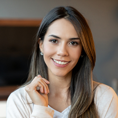 Portrait of a beautiful woman at home looking at the camera smiling - lifestyle concepts