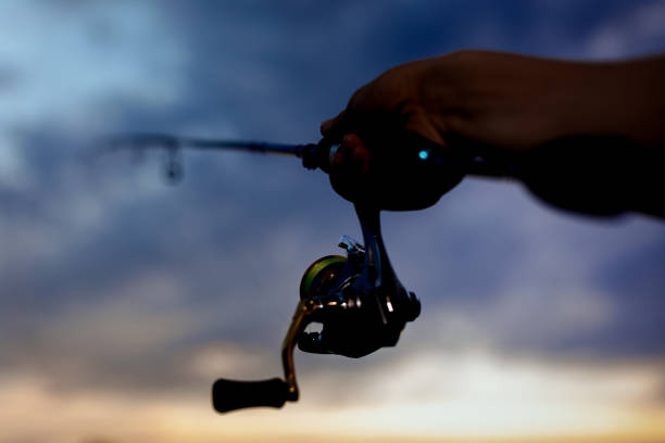 istock Fishing in the river at sunset. 1012003768
