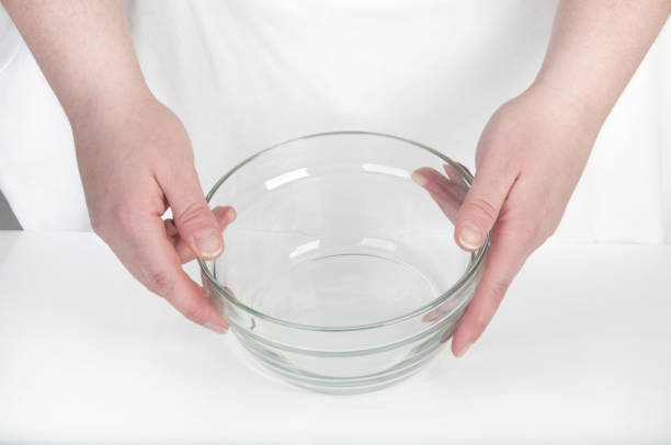 istock Empty glass bowl in female hands 1012011020