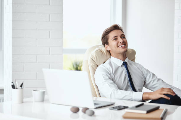 istock Young handsome businessman smiling in a modern office 1012011304