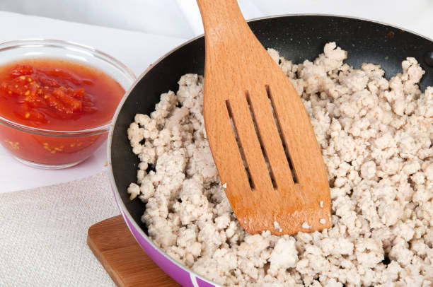 istock Tomato puree in a glass bowl and chopped meat 1012013828