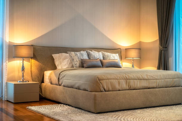 istock Bed and nightstand in modern bedroom and equipment for a comfortable and restful experience. 1012019328