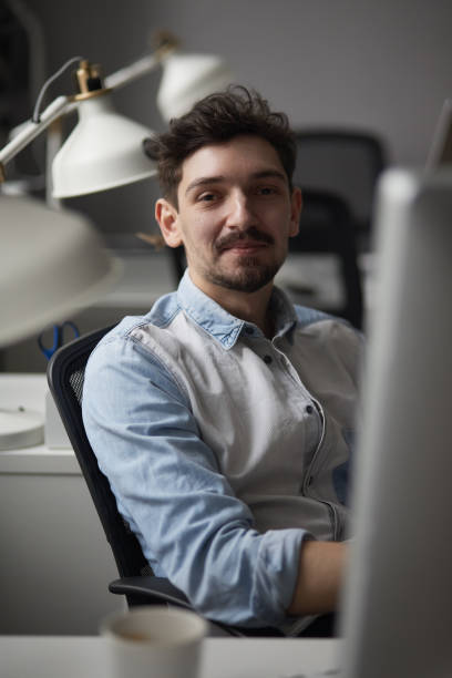 istock Young intelligent man working at modern loft studio-office with 1012020156