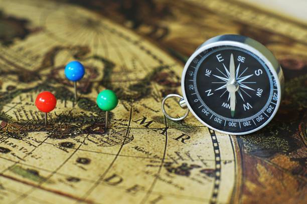 istock Compass and marking pins on blur vintage world map, journey concept, copy space 1012023362