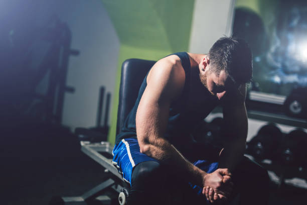 istock Young handsome man is prepared for exercise in the gym. 1012027302