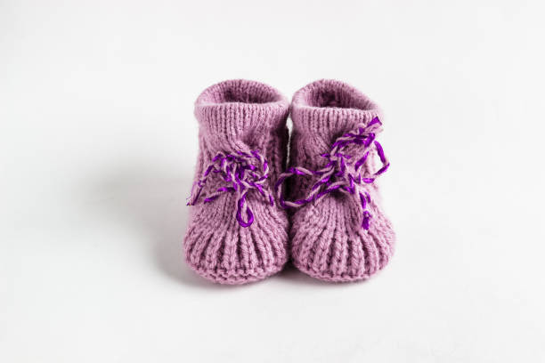 istock Knitted baby booties on white background. 1012027662