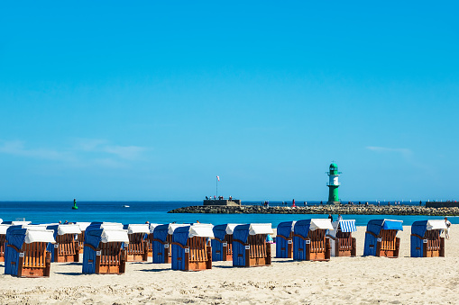 Beach and mole with blue sky in Warnemuende, Germany