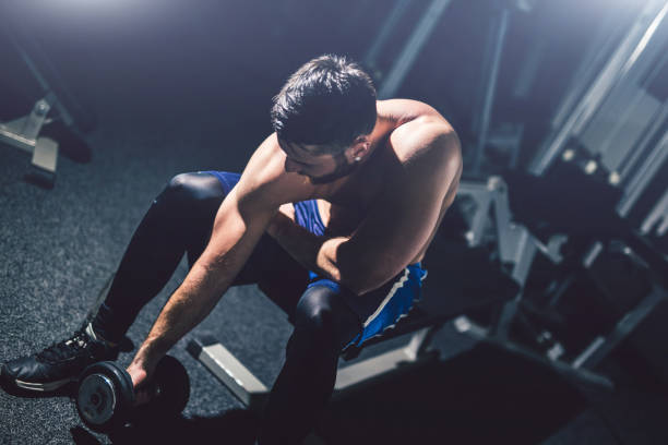 istock Young handsome man exercise in the gym. 1012032708