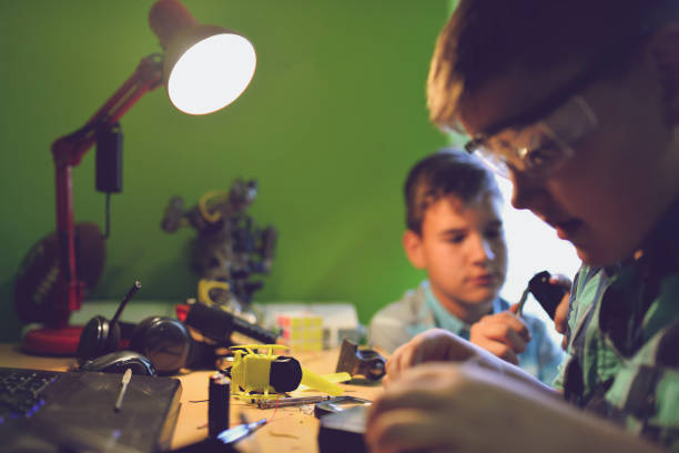 istock Small engineers working on innovative robots in their room 1012035852