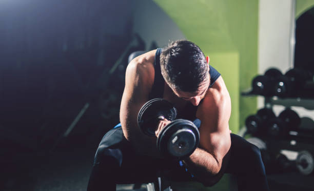 istock Young handsome man exercise in the gym. 1012036012