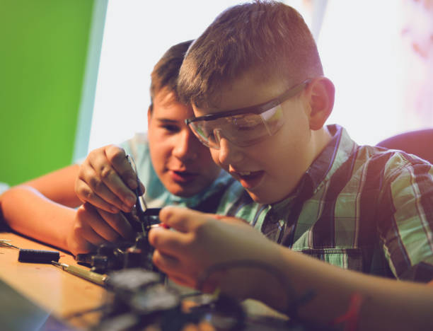 istock Small engineers working on innovative robots in their room 1012036094