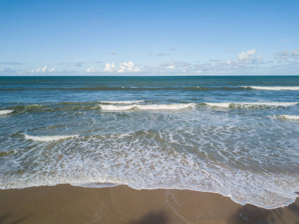 istock View of waves at sea with blue sky in background 1012036450