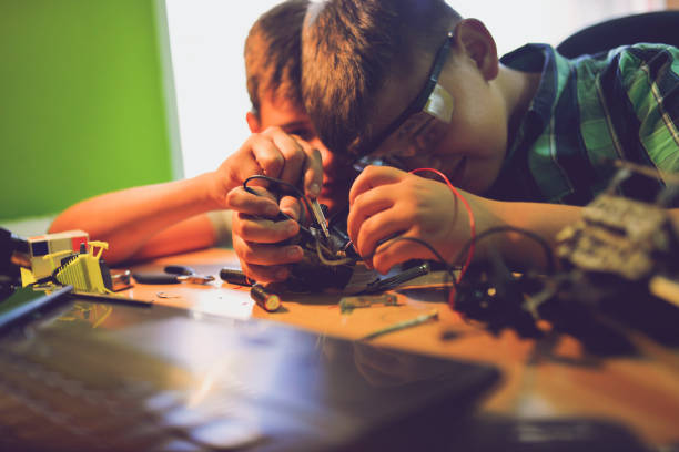 istock Small engineers working on innovative robots in their room 1012045188