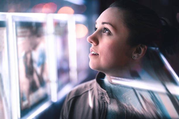 Serious thoughtful woman looking at city lights at night in dark. Dramatic face with reflection of billboard signs. Pensive lady thinking. Serious thoughtful woman looking at city lights at night in dark. Dramatic face with reflection of billboard signs. Pensive lady thinking. Side view. human face light stock pictures, royalty-free photos & images