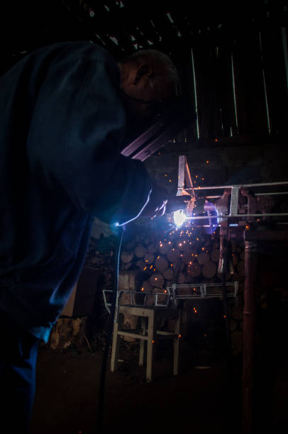 istock Welder welding metal in workshop with sparks 1012051502