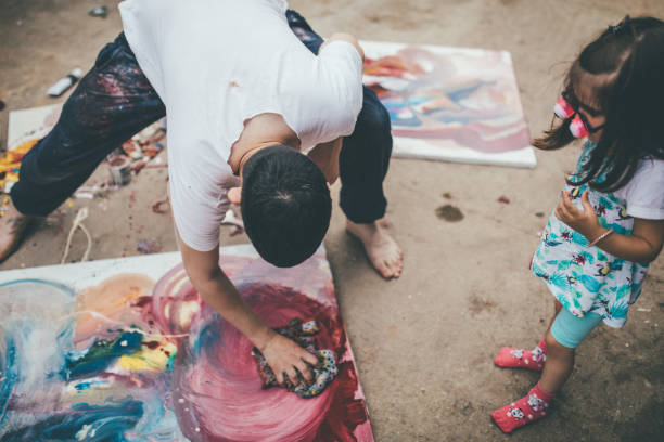 istock Little girl watching artist work 1012051630