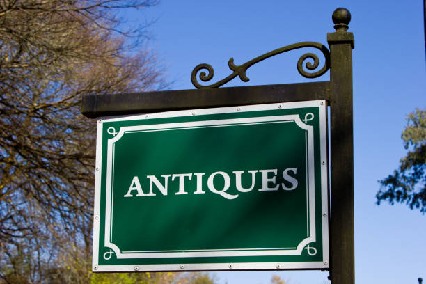 istock Signboard with word ANTIQUES in white letters on green background 1012052068