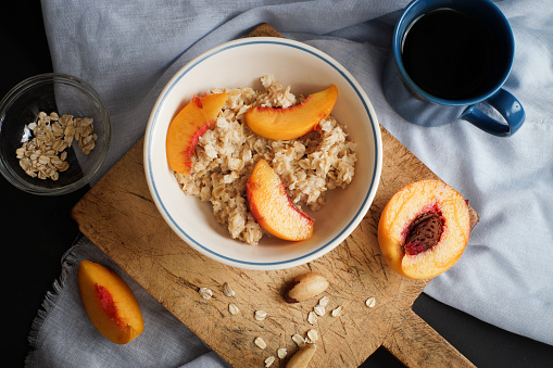 Healthy breakfast dish of oatmeal and peaches