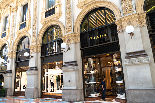 Milan, Italy - July 29, 2018: Prada store signage. Prada S.p.A. is an Italian luxury fashion house specializing in leather handbags, travel accessories, shoes, ready-to-wear, perfumes