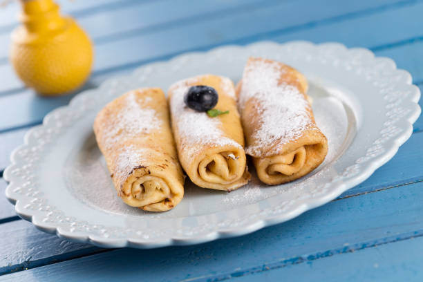 istock Three homemade rolled pancakes with blueberry 1012078318