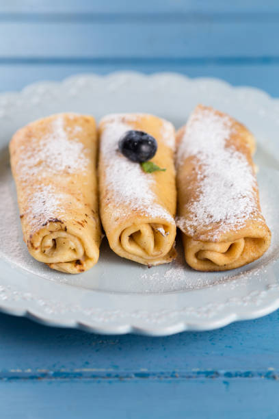 istock Three homemade rolled pancakes with blueberry 1012078326