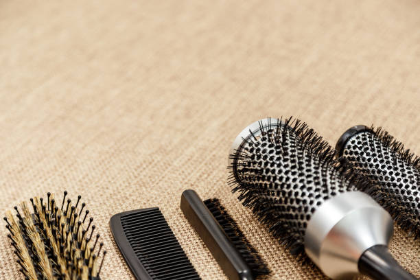 istock Combs and hairdresser tools on beige background 1012081050