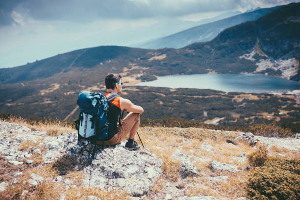 istock Man on the mountain top enjoying nature 1012082708
