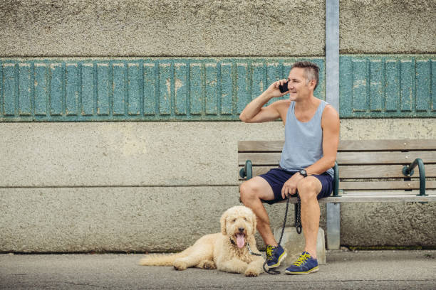 istock Dog walker taking a break at the station 1012082774