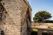 The entrance with a small drawbridge from the old defence tower of Punta de N'Amer near Sa Coma, on the Spanish Balearic Mediterranean island of Mallorca