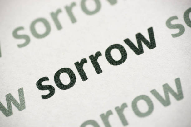 istock word sorrow printed on paper macro 1012090288
